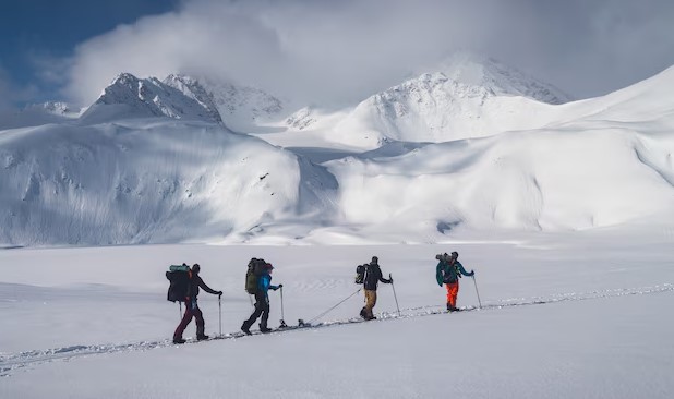 A group of climbers trekking through deep snow towards Gasherbrum II, the 13th highest mountain in the world, in Pakistan’s Karakoram. Karakoram Range.